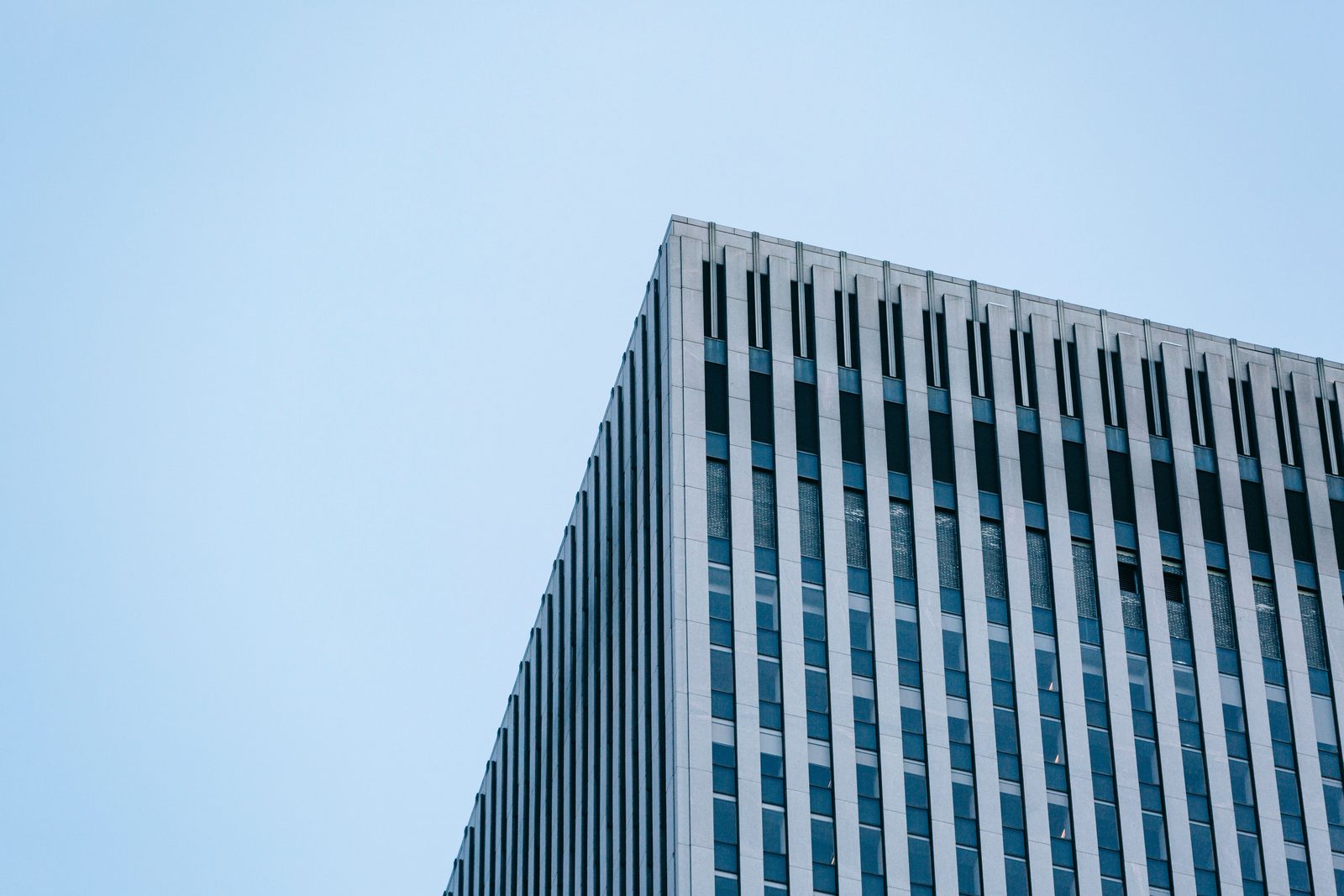 Upper corner of an office tower against clear sky
